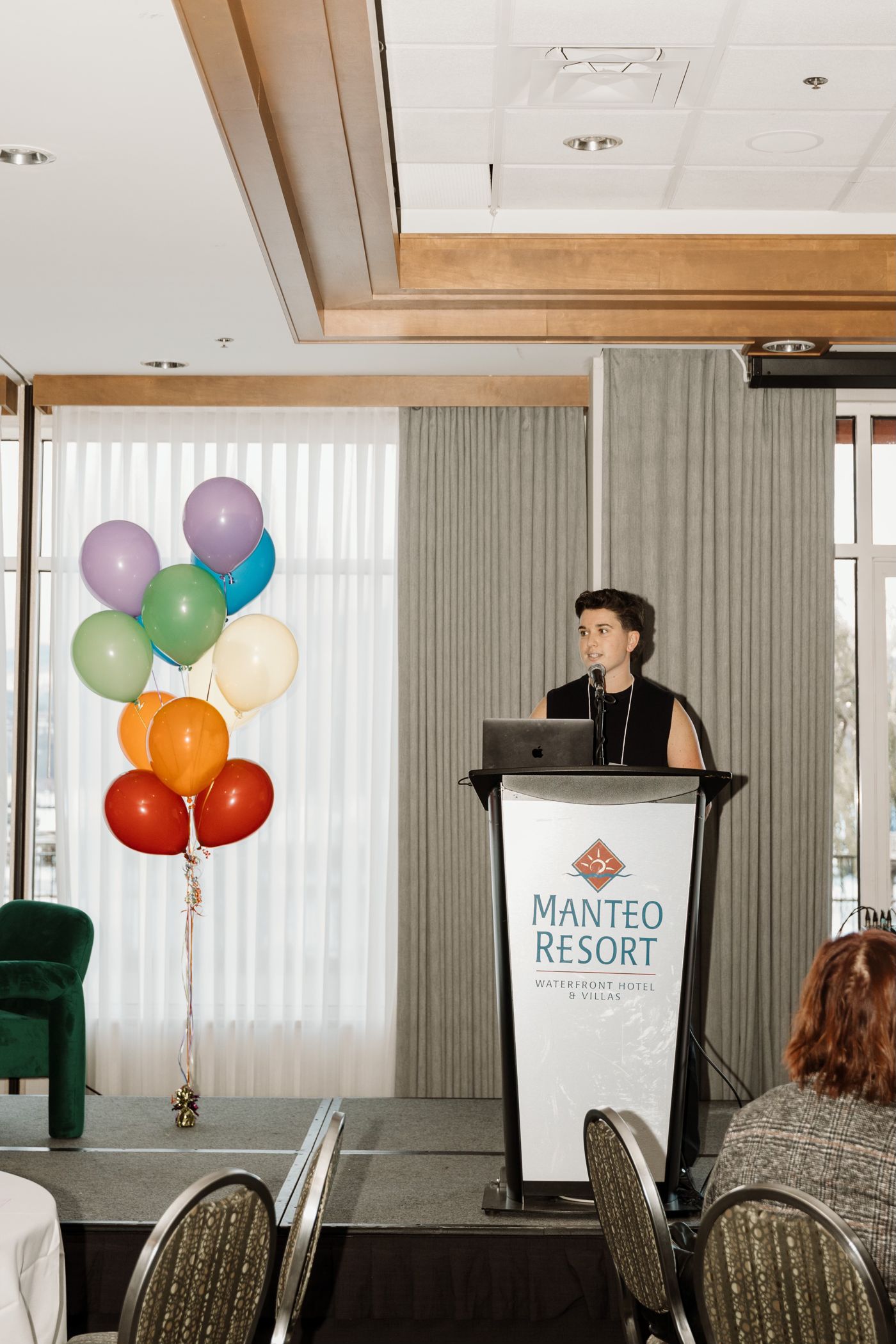 Speaking at a podium at the SPARK event, Manteo Resort